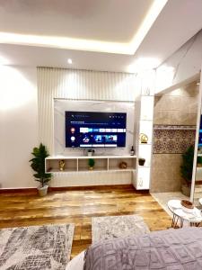 a living room with a large flat screen tv at Riyadh season studio in Riyadh