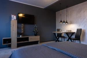 a bedroom with a bed and a table with a christmas tree at T - Polis in Subotica