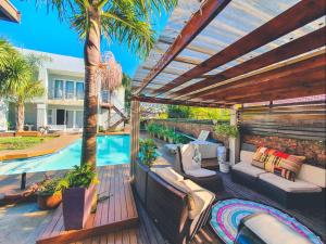 an outdoor patio with a pool and a pergola at Blue View B&B in East London