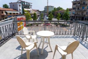 a table and chairs on a balcony with a view of a city at BnB Martin in Jesolo