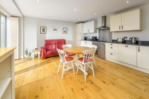 a kitchen and dining room with a table and chairs at The Coach House in Bamburgh