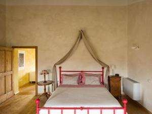 a bedroom with a red and white bed with a canopy at Agriturismo Viridarium in Castellucchio +31 photos