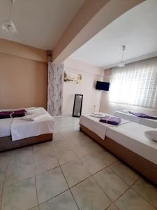 a bedroom with two beds and a window at Zeytindali Apart Hotel in Didim
