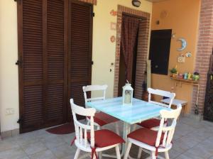a dining room with a blue table and chairs at affitto appartamento sul mare in Senigallia +7 photos