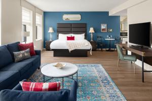 a living room with a bed and a couch at Landmark Inn in Marquette