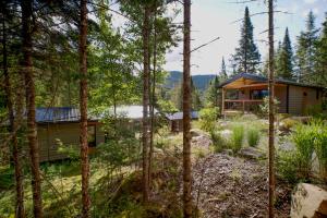 a cabin in the woods with trees at Nordique spa Stoneham in Stoneham +24 photos