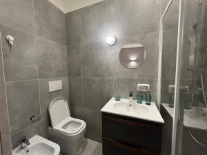 a bathroom with a toilet and a sink and a shower at La Nicchia in Bari