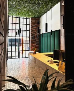 an office with a long desk and a large window at Apartahotel Medellin in Medellín