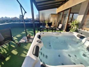 a hot tub on the patio of a house at Arcobaleno Apartments & Rooms in Varaždin