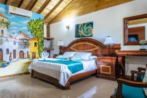 1 dormitorio con 1 cama con una pintura en la pared en Hotel Isla Lizamar, en Isla Grande