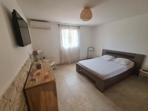 a bedroom with a bed and a television in it at Appartement Vacances ZEN in Fréjus