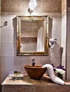 a bathroom with a wooden sink and a mirror at Hotel Doupiani House in Kalabaka