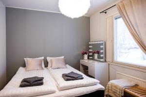 una camera da letto con due letti e una finestra di Arctic River House a Rovaniemi