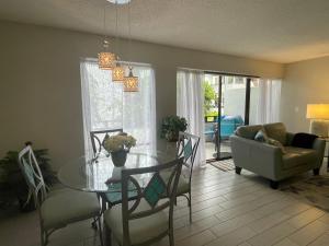 a living room with a glass table and a couch at Glory Beach Haven in Venice