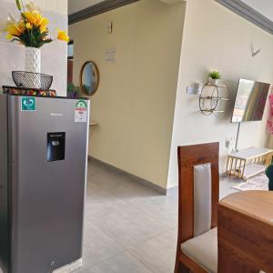 a refrigerator with a trash can on top of it at LES INTERNATIONAL in Mombasa