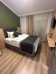 a bedroom with a bed and a television in it at Pendik Marine Hotel in Istanbul