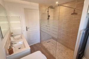 a bathroom with a toilet and a sink and a shower at La Grange in Gasny +6 photos