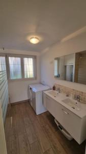 a bathroom with a sink and a toilet and a mirror at La Grange in Gasny