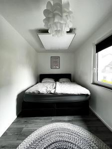 a bedroom with a bed and a chandelier at Alte Backstube - Kaiserslautern in Kaiserslautern