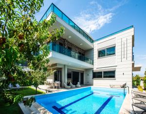 an image of a house with a swimming pool at Living Dream Villa HARMONY in Belek