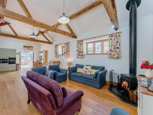 a living room with two couches and a fireplace at 4 Bed in Church Stretton 87695 in Cardington