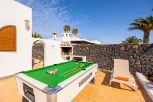 a pool table on a patio with a wall at Villa Alisa in Tías