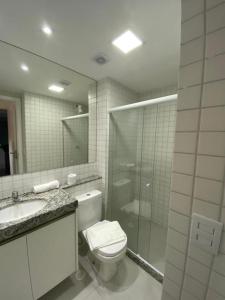 a bathroom with a toilet and a shower and a sink at Cupe Beach Living Concept 304E in Porto De Galinhas