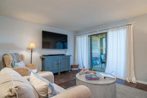 a living room with a couch and a table at 1341 Pelican Watch Villa in Seabrook Island