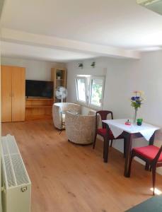 a living room with a table and chairs at APARTMENTS / WOHNUNG IN HAIBACH in Haibach