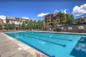 a swimming pool at a resort with blue water at Hyatt Residence Club Main Street Station in Breckenridge