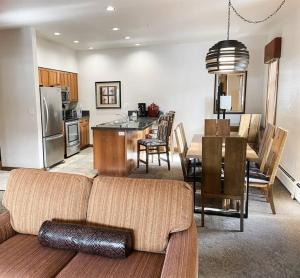 a living room with a couch and a kitchen with a table at Hyatt Residence Club Main Street Station in Breckenridge