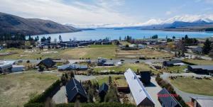 an aerial view of a resort with a lake and mountains at Lake View Studio in Lake Tekapo