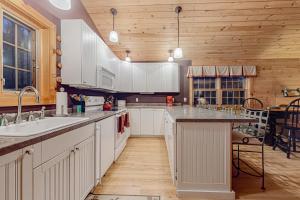 a kitchen with white cabinets and a counter top at The Loft at Pine Rock in Weston