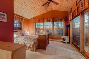a bedroom with a bed and large windows at The Loft at Pine Rock in Weston