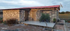 a small house with a stone building with a door at Borak's Stone Village in Rizokarpaso