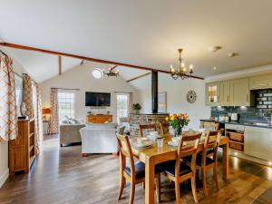 a kitchen and living room with a table and chairs at 3 Bed in Westward Ho 89869 in Westward Ho