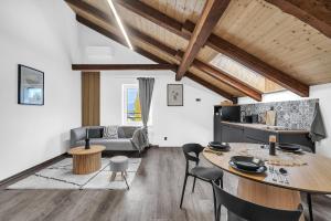 a kitchen and living room with a table and chairs at Hotel U Krále Jiřího in Stráž pod Ralskem