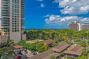 an aerial view of a resort with palm trees and buildings at The Regency at Beachwalk - Unit 93 in Honolulu