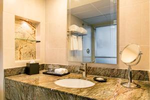 a bathroom with a sink and a mirror at Sheraton Grand Panama in Panama City