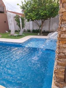 una piscina con cascada en una casa en Casa Paraná en Paraná