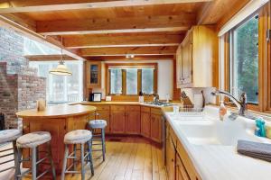a kitchen with wooden cabinets and a large window at Whistling Peak in Wilmington +54 photos