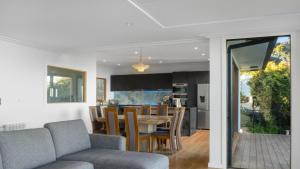 a dining room and kitchen with a table and chairs at Sunset Haven in Nelson in Nelson