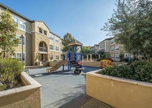 a playground with a slide in a courtyard at Santa Clara 2br w pool balcony elevator gym SFO-1587 in Santa Clara