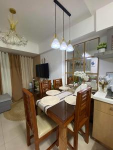 a kitchen and dining room with a table and chairs at The Residences at Commonwealth by Century in Manila
