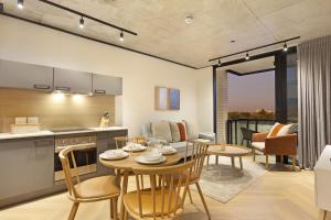 a kitchen and dining room with a table and chairs at Bridgewater View 502 by HostAgents in Cape Town