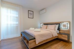 a bedroom with a large bed with two towels on it at IMPERIAL of LUGANO apartment-behind the station with FREE parking in Lugano