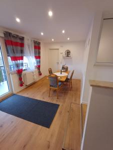 a dining room and living room with a table and chairs at APARTMENTS / WOHNUNG IN HAIBACH in Haibach