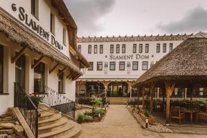 a building with a restaurant and a stairway down at Hotel Slamený dom in Košice