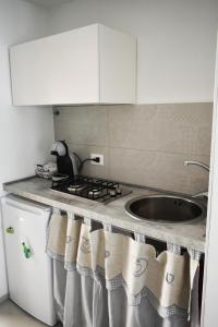 a kitchen with a sink and a stove at Casa Vacanze La Dimora di Santa Barbara in Petralia Soprana