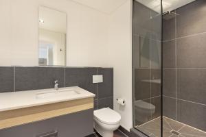 y baño con aseo, lavabo y ducha. en Bridgewater View 415 by HostAgents, en Ciudad del Cabo